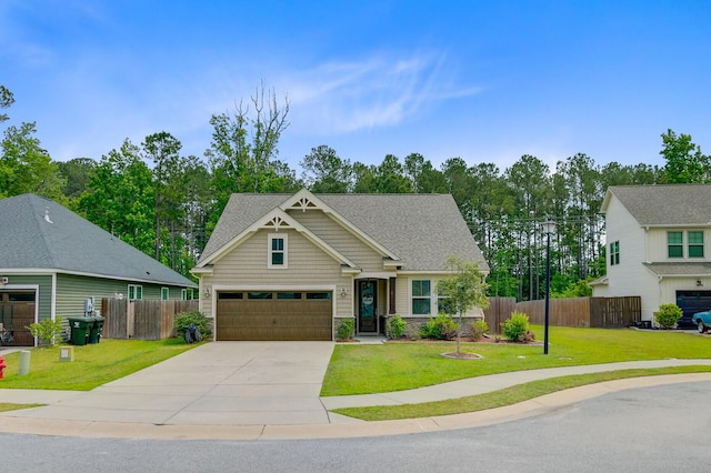 craftsman-style house with roof with shingles, fence, a front yard, and driveway