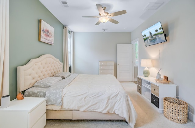 bedroom featuring ceiling fan, light carpet, and visible vents