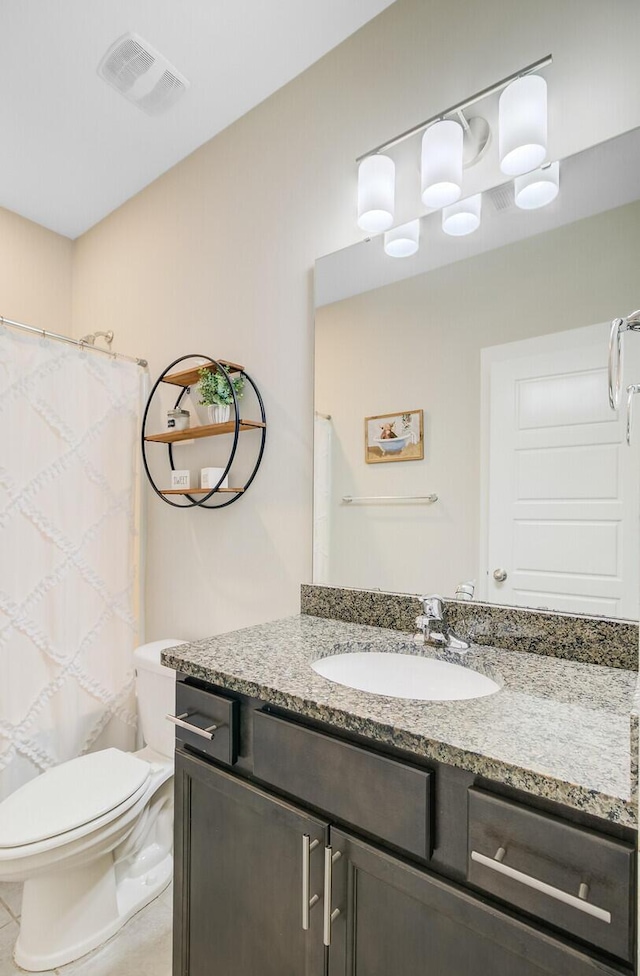 bathroom featuring toilet, visible vents, curtained shower, and vanity