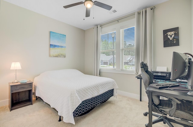 bedroom featuring light colored carpet, visible vents, baseboards, and a ceiling fan