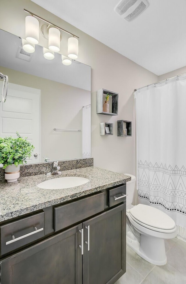bathroom featuring toilet, visible vents, tile patterned flooring, and vanity