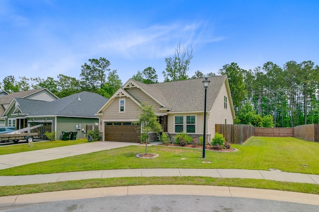 craftsman-style house featuring driveway, fence, stone siding, a front yard, and roof with shingles