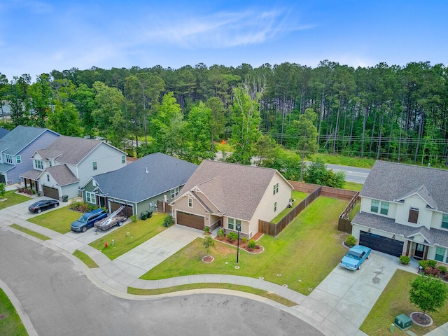 drone / aerial view with a residential view and a view of trees