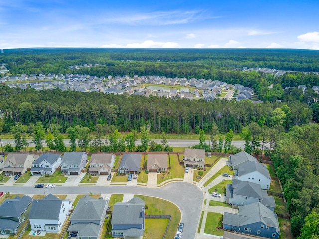 bird's eye view featuring a wooded view and a residential view
