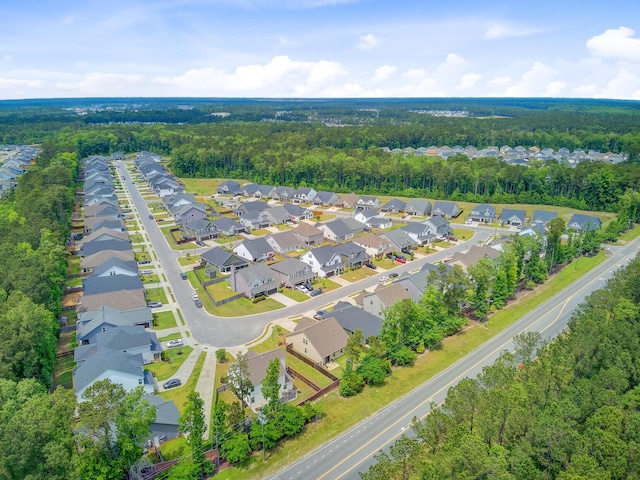 aerial view featuring a forest view and a residential view