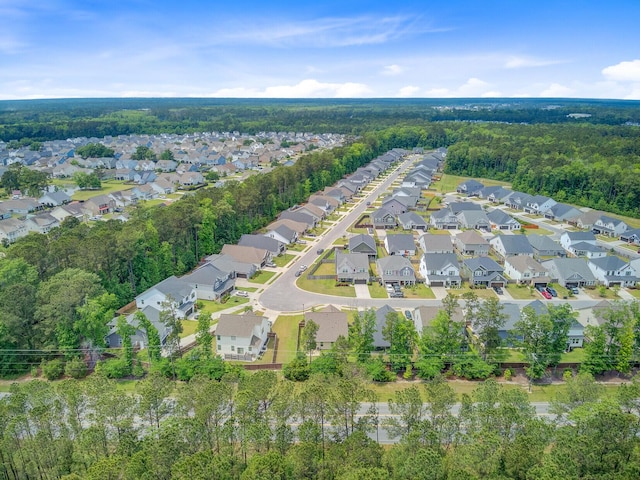 birds eye view of property featuring a view of trees and a residential view