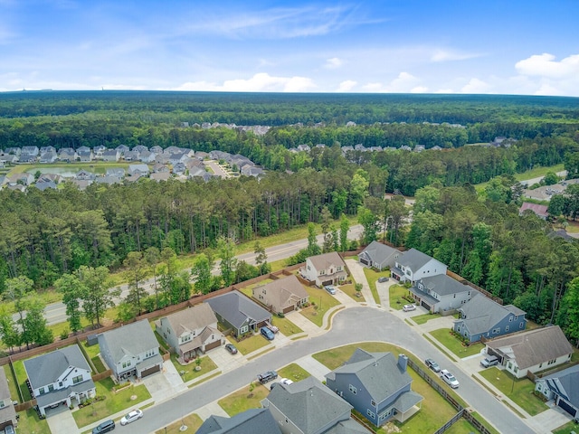 drone / aerial view with a forest view and a residential view