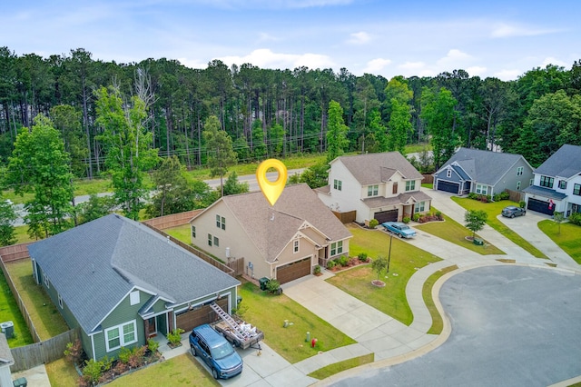 bird's eye view featuring a forest view and a residential view