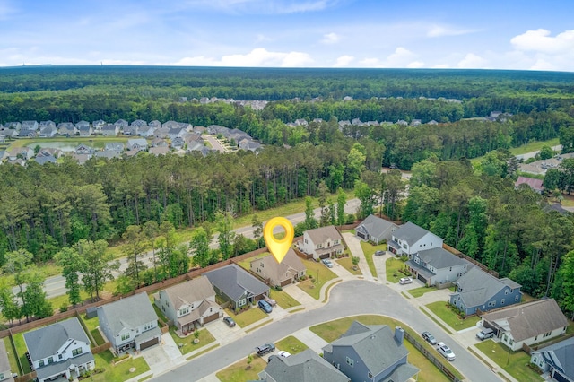 drone / aerial view with a forest view and a residential view