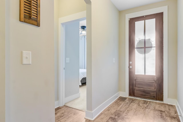 entryway with baseboards and wood finished floors