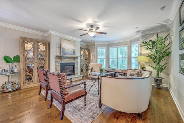 3152 Riverine, Charleston, SC 29414 - living area with a ceiling fan, wood-type flooring, a stone fireplace, ornamental molding, and baseboards