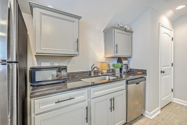 3152 Riverine, Charleston, SC 29414 - kitchen featuring stainless steel appliances, a sink, gray cabinets, light wood-type flooring, and dark stone countertops