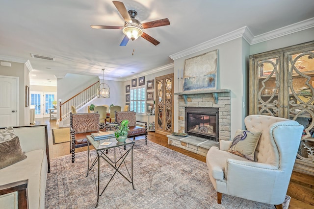 3152 Riverine, Charleston, SC 29414 - living area with stairs, wood finished floors, a ceiling fan, a stone fireplace, and ornamental molding