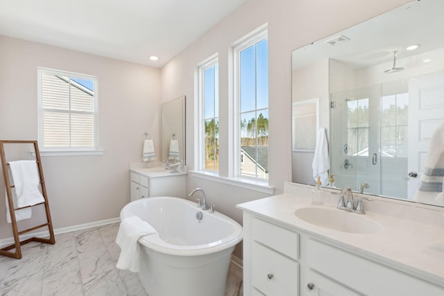 bathroom with a sink, plenty of natural light, marble finish floor, and a shower stall