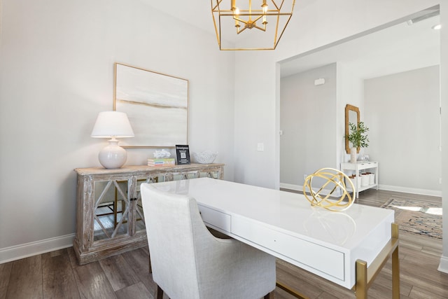 dining room featuring visible vents, wood finished floors, baseboards, and a chandelier