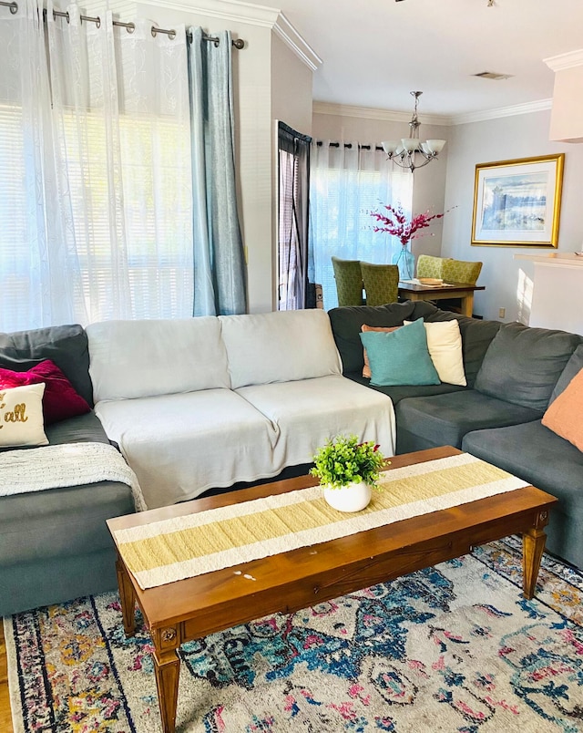 living room featuring an inviting chandelier and ornamental molding