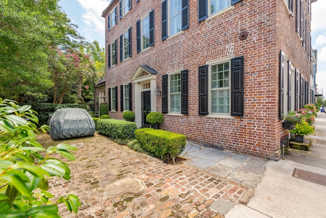 view of property exterior featuring brick siding