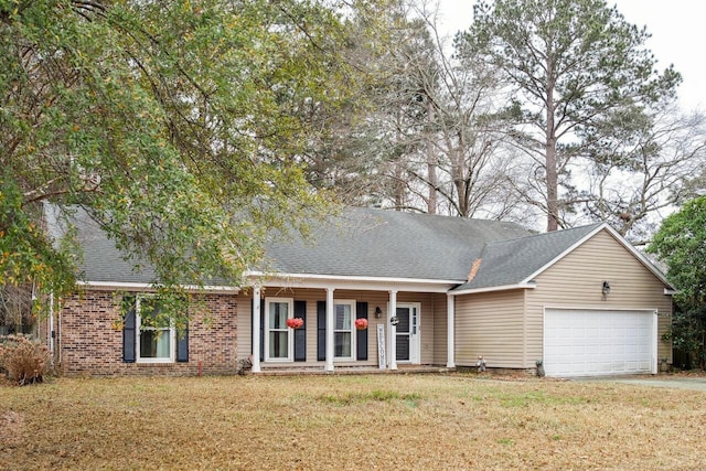 view of front of house featuring a shingled roof, brick siding, an attached garage, and a front lawn