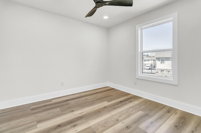 empty room featuring a ceiling fan, recessed lighting, light wood-style flooring, and baseboards