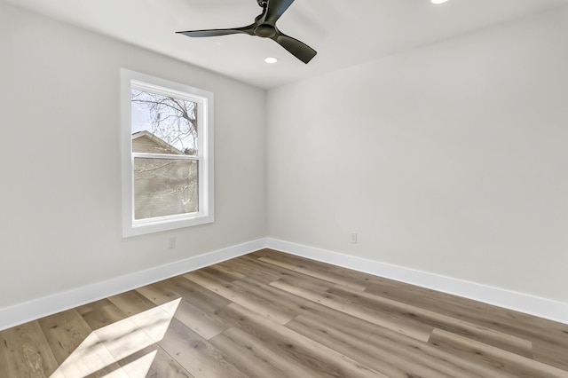 unfurnished room featuring ceiling fan, baseboards, wood finished floors, and recessed lighting