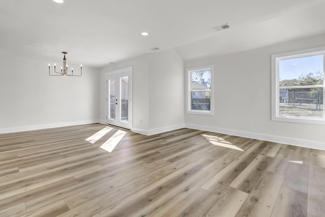 empty room featuring light wood-style floors, recessed lighting, plenty of natural light, and baseboards