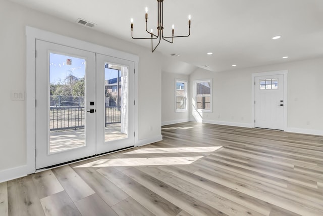 doorway to outside featuring light wood-style floors, recessed lighting, baseboards, and french doors