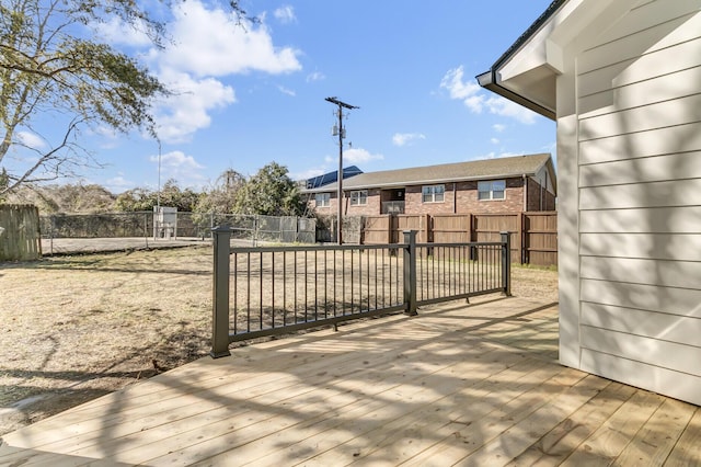 view of gate with a fenced backyard and a deck