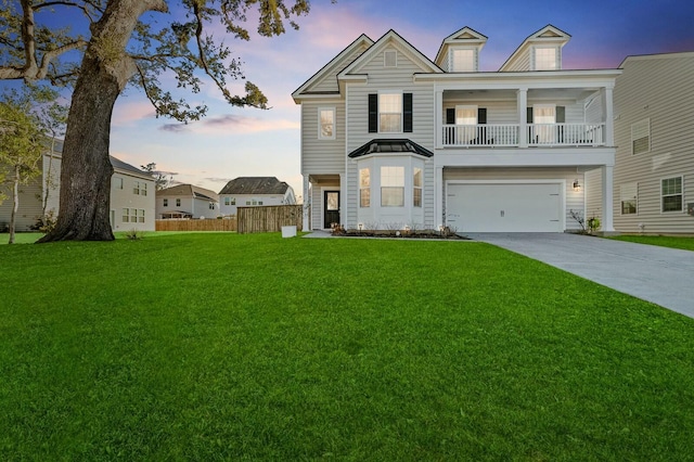 view of front of property with a yard, a garage, and a balcony