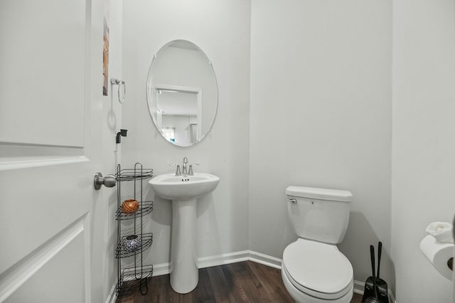 bathroom featuring sink, hardwood / wood-style floors, and toilet