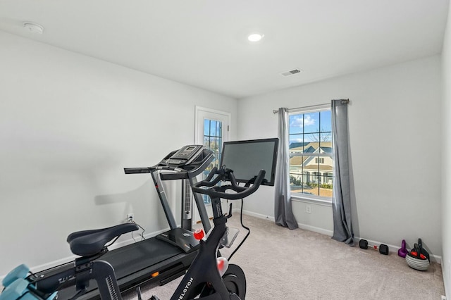 exercise room with light colored carpet