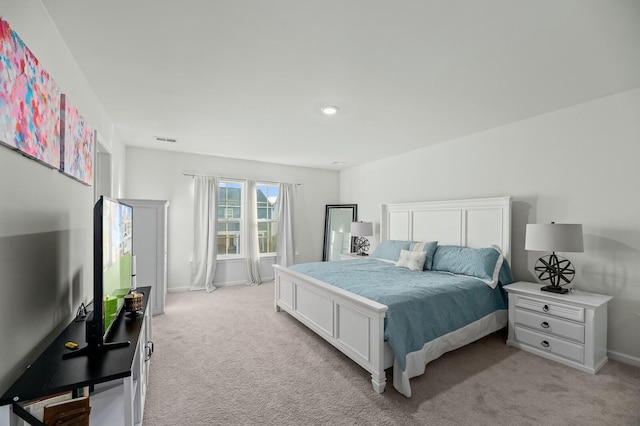 bedroom featuring light carpet