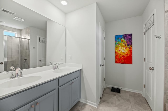 bathroom with walk in shower, tile patterned floors, and vanity