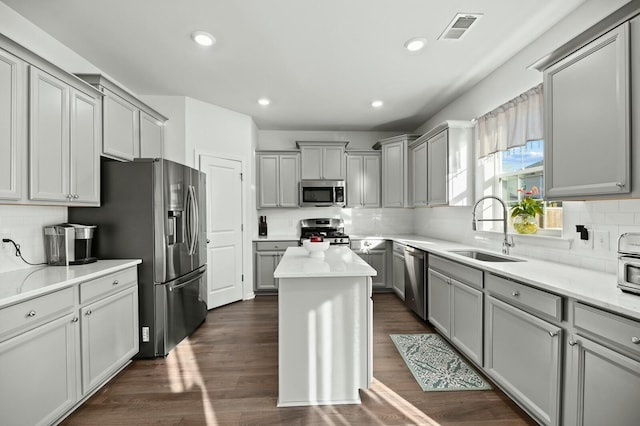 kitchen featuring gray cabinets, appliances with stainless steel finishes, sink, and dark hardwood / wood-style floors