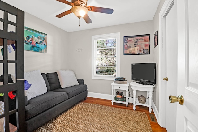 living room featuring hardwood / wood-style flooring and ceiling fan