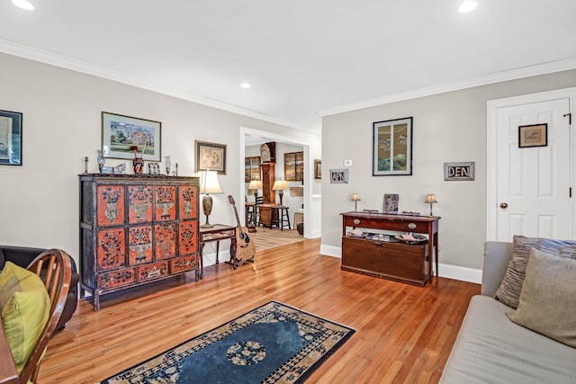 living room featuring wood-type flooring and crown molding