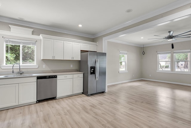62 Wexford Way, Walterboro, SC 29488 - kitchen featuring stainless steel appliances, a sink, white cabinetry, ornamental molding, and light wood-type flooring
