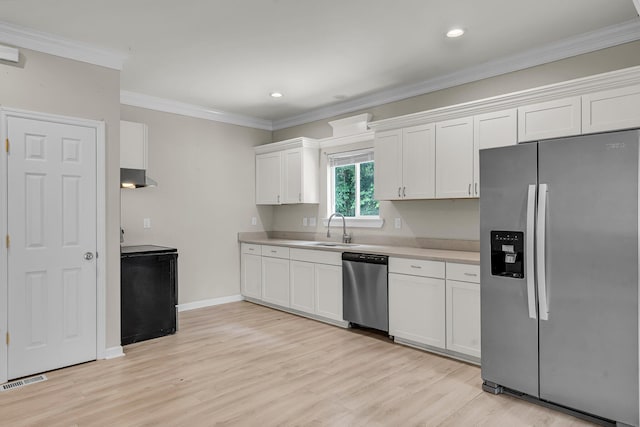 62 Wexford Way, Walterboro, SC 29488 - kitchen with appliances with stainless steel finishes, a sink, light countertops, light wood-type flooring, and white cabinetry