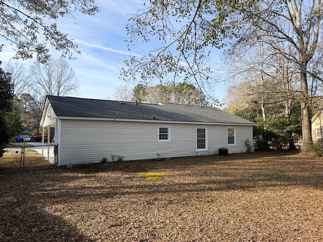 rear view of house with central AC unit