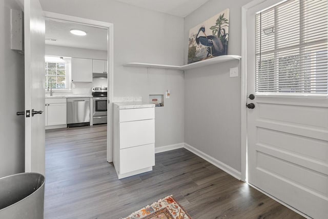 washroom with washer hookup, dark hardwood / wood-style flooring, a textured ceiling, and sink