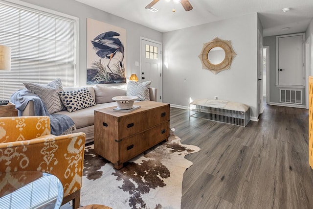 living room with ceiling fan and dark hardwood / wood-style flooring