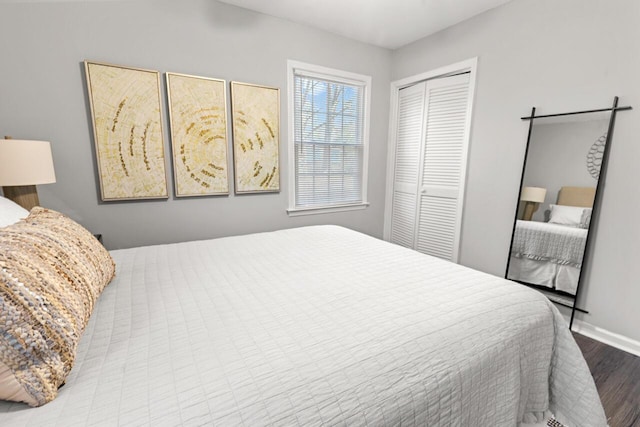 bedroom with light wood-type flooring and a closet