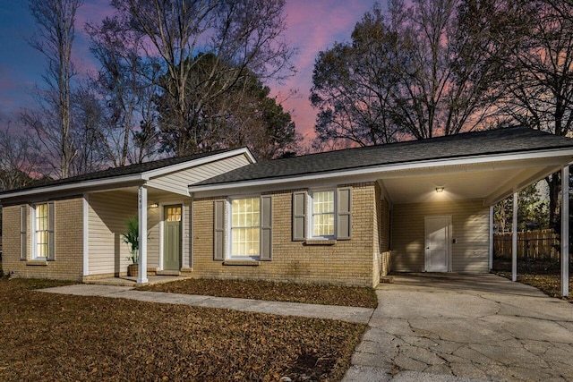 ranch-style house featuring a carport