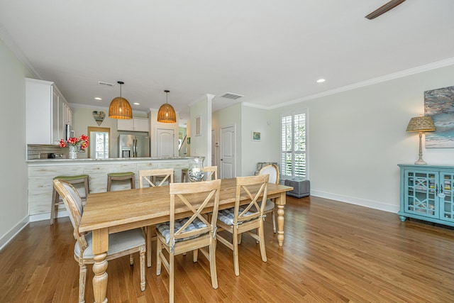 dining space featuring light hardwood / wood-style floors and ornamental molding