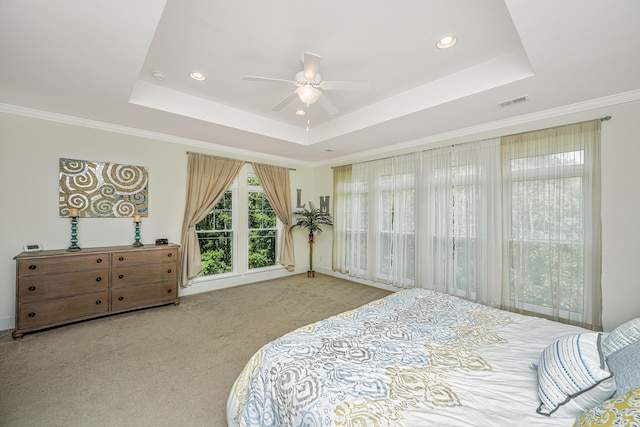 carpeted bedroom featuring a raised ceiling, ceiling fan, and crown molding