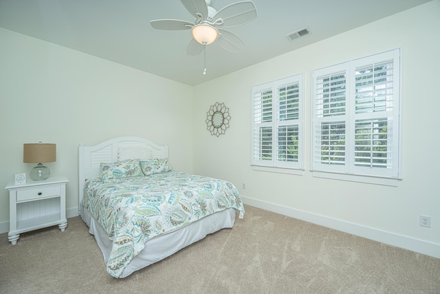 bedroom featuring light carpet and ceiling fan