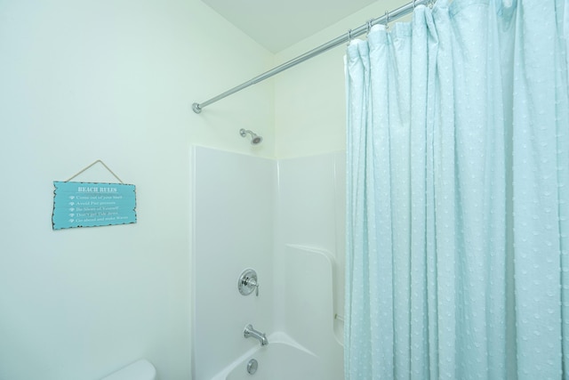 bathroom with toilet and shower / tub combo with curtain