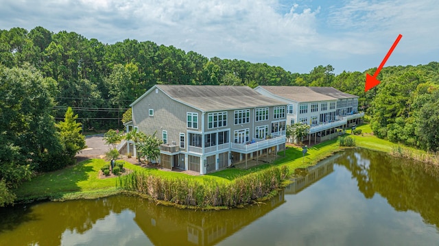 back of property with a water view