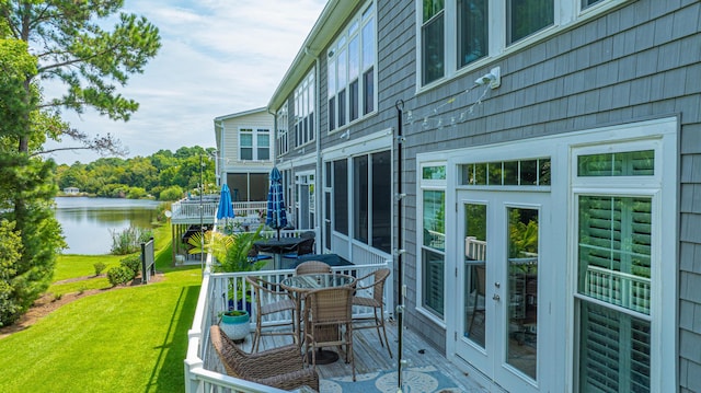 balcony featuring a deck with water view