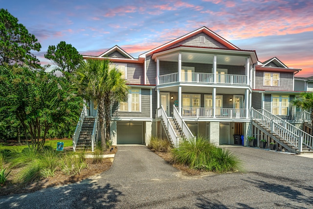 raised beach house featuring covered porch