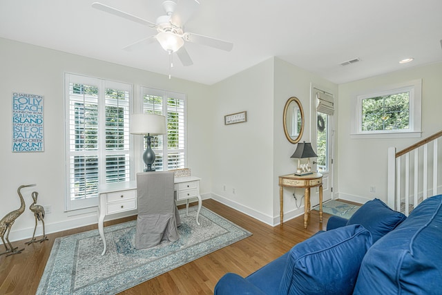 office with ceiling fan and dark wood-type flooring